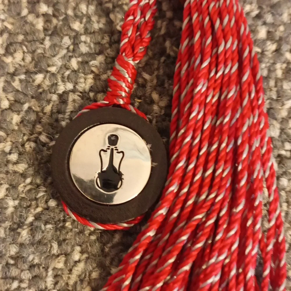 The Sak red and brown leather keychain the Sak emblem
